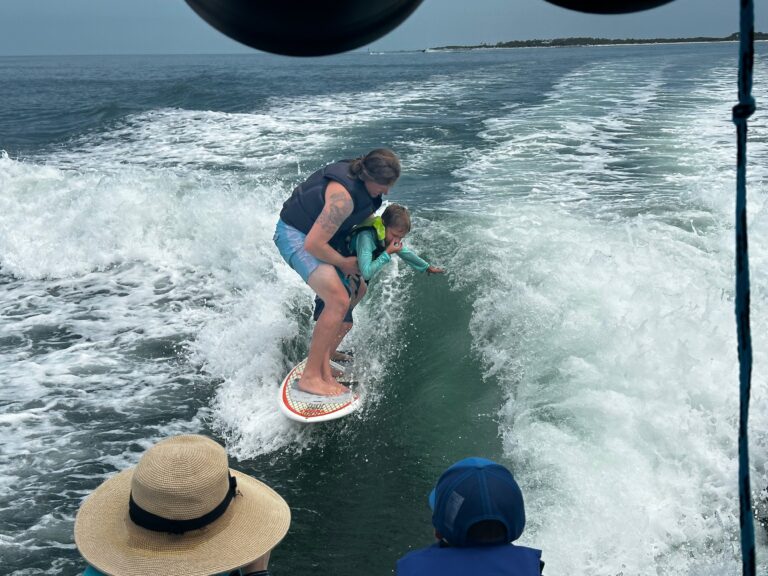 Man wakesurfing with child Clearwater Beach